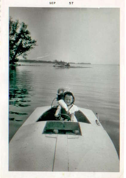 Bill VanVlack at age 6 driving a boat